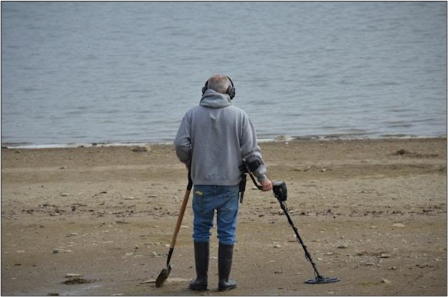 Image showing a man with metal detector headphones on.